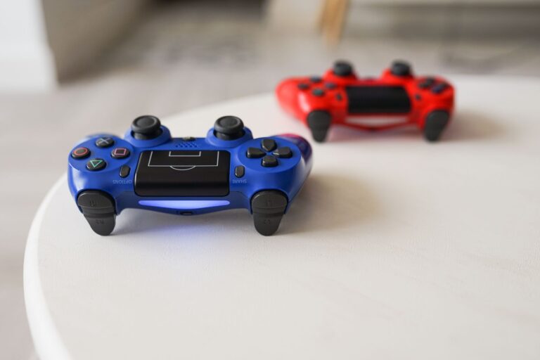 Close-up of PlayStation controllers on a white table for gaming enthusiasts.